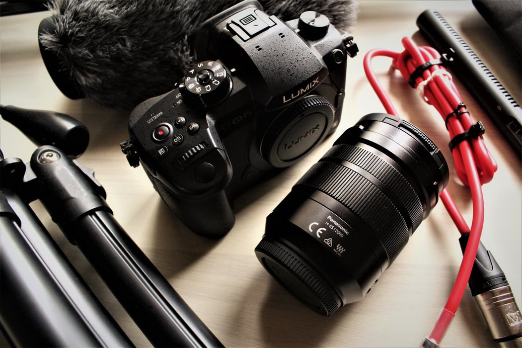 Black Lumix Dslr Camera on Brown Wooden Table